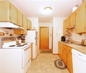 Fredericton apartment for rent - A kitchen with wooden cabinets and white appliances.