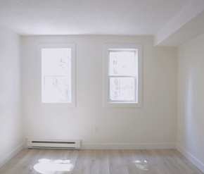 Halifax apartment for rent - A room with two windows and a radiator on the floor.