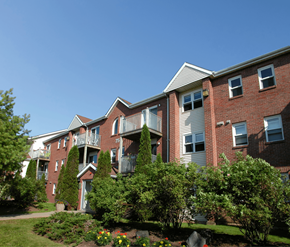 Halifax apartment for rent - A red brick apartment building with a green lawn in front.