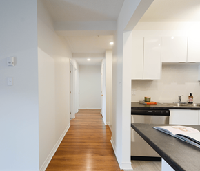 Halifax apartment for rent - A kitchen with white cabinets and a black countertop.
