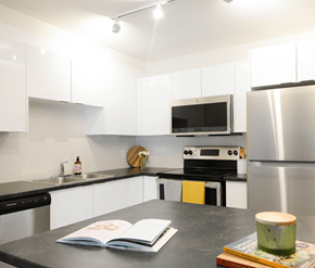 Halifax apartment for rent - A modern kitchen with a black countertop and stainless steel appliances.