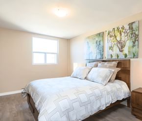 London apartment for rent - A bedroom with a large bed and two paintings on the wall.