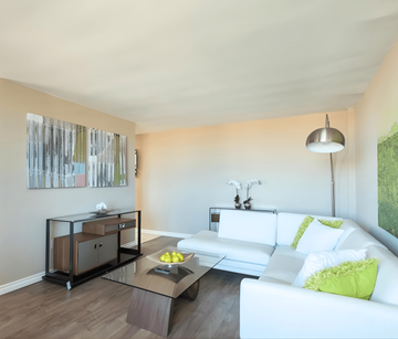 London apartment for rent - A modern living room with a white couch and a glass coffee table.