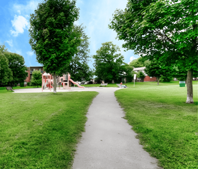 London apartment for rent - A playground with a slide is in the middle of a grassy area.