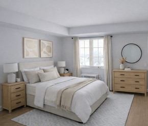 Moncton apartment for rent - A bedroom with a large bed, two nightstands, and a round mirror on the wall.