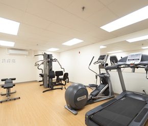 Moncton apartment for rent - A gym with a treadmill, exercise bike, and other equipment.