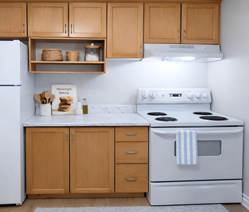 Moncton apartment for rent - A kitchen with a white stove and wooden cabinets.