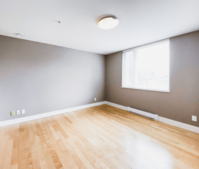 St. Johns apartment for rent - A room with a wooden floor and a window.