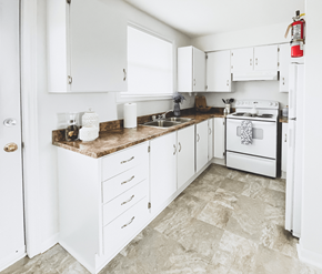 St. John's apartment for rent - A kitchen with white cabinets and a white stove.