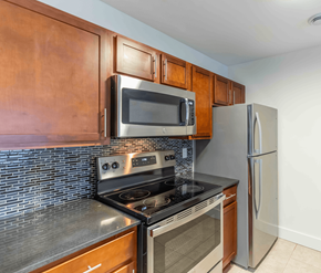 Saint John apartment for rent - A kitchen with a stove, oven, microwave, and refrigerator.
