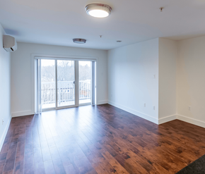 Saint John apartment for rent - A room with a sliding glass door and wood flooring.