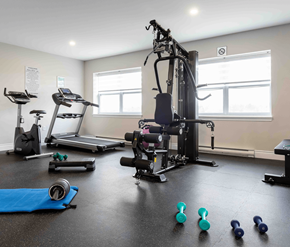 Saint John apartment for rent - A gym with a variety of equipment including treadmills, elliptical machines, and weights.