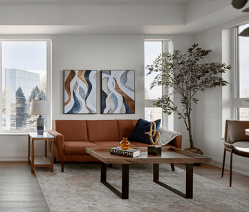 Waterloo apartment for rent - A living room with a brown couch, a coffee table, and a large painting on the wall.