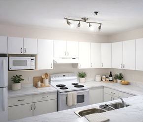 Moncton apartment for rent - A kitchen with white cabinets and a white fridge.