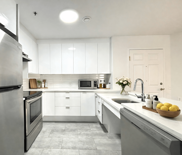 Moncton apartment for rent - A modern kitchen with white cabinets and stainless steel appliances.