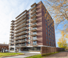Moncton apartment for rent - A tall apartment building with balconies on each floor.