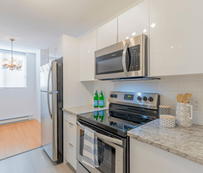 Moncton apartment for rent - A modern kitchen with a stove, oven, and microwave.
