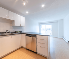 Saint John apartment for rent - A kitchen with white cabinets and a black dishwasher.