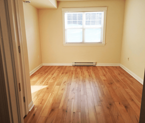 Fredericton apartment for rent - A room with wooden flooring and a window.