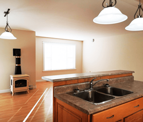 Fredericton apartment for rent - A kitchen with a wood stove and a sink.