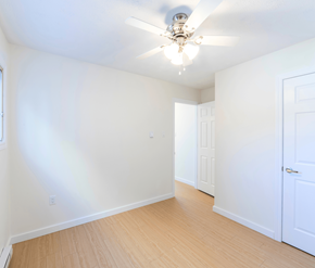 Saint John apartment for rent - A room with a ceiling fan and two doors.