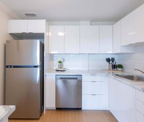 Moncton apartment for rent - A modern kitchen with a stainless steel refrigerator and dishwasher.