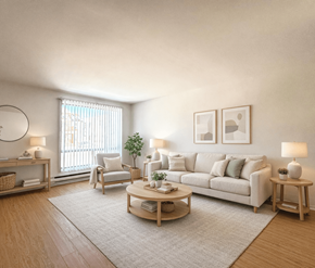 Moncton apartment for rent - A living room with a white couch, a wooden coffee table, and a window with blinds.
