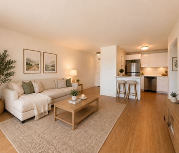 Moncton apartment for rent - A living room with a white couch and a coffee table.