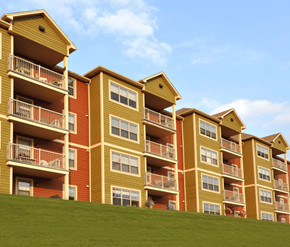Dieppe apartment for rent - Apartment buildings with balconies and windows are lined up on a grassy hill.