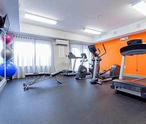 St. Johns apartment for rent - A gym with a variety of equipment including a treadmill, exercise bike, and rowing machine.