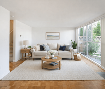 Victoria apartment for rent - A living room with a white couch and a coffee table.