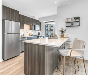 Kitchener apartment for rent - A modern kitchen with a stainless steel refrigerator and a white countertop.