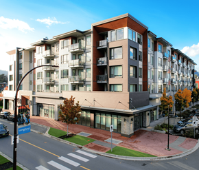 Victoria apartment for rent - A modern apartment building with a street in front.