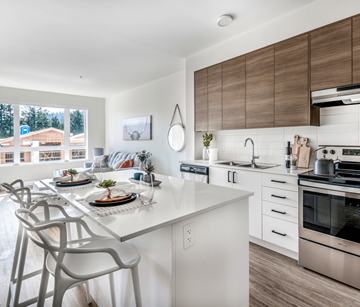 Victoria apartment for rent - A modern kitchen with a dining table set for two.