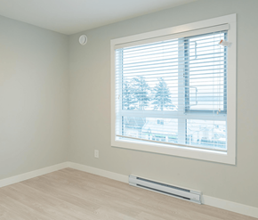 Courtenay apartment for rent - A room with a window showing a view of a residential area.