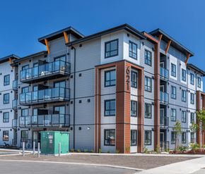 Courtenay apartment for rent - A modern apartment building with a mix of grey, brown, and blue tones.