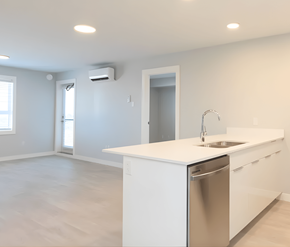 Courtenay apartment for rent - A modern kitchen with white cabinets and a stainless steel dishwasher.