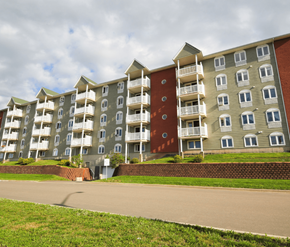 Moncton apartment for rent - Apartment building with a red door on the side.