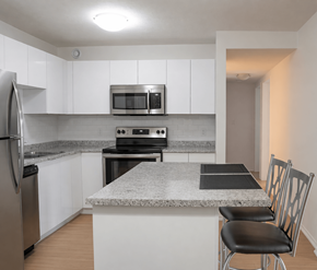 Moncton apartment for rent - A kitchen with a granite countertop and stainless steel appliances.