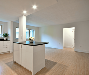 Fredericton apartment for rent - A kitchen with white cabinets and a black countertop.