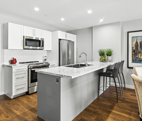 Moncton apartment for rent - A modern kitchen with a marble countertop and stainless steel appliances.