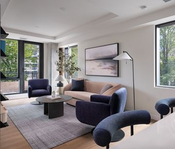 Halifax townhouse for rent - A living room with a grey rug and a large painting on the wall.
