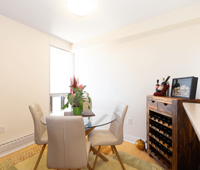 Fredericton apartment for rent - A dining room with a glass table and chairs.