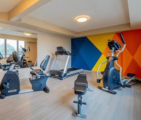 Saint John apartment for rent - A gym with a row of exercise bikes and elliptical machines.