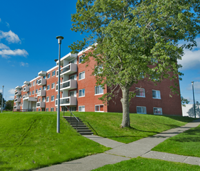 St. Johns apartment for rent - A red brick apartment building with a tree in front.