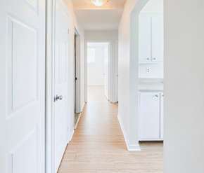 St. Johns apartment for rent - A long hallway with white doors and cabinets.