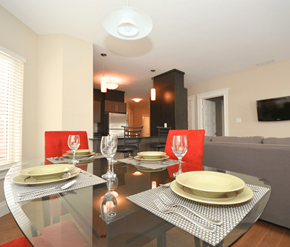 Dieppe apartment for rent - A modern dining room with a glass table set for two.