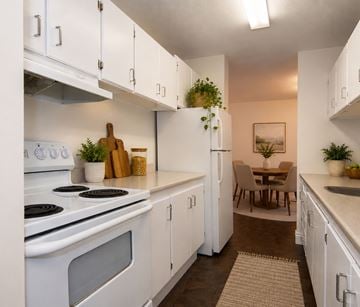 Halifax apartment for rent - A kitchen with white cabinets and a stove top oven.