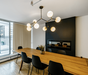 Calgary apartment for rent - A modern dining room with a wooden table and black chairs.