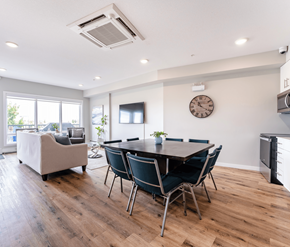 Edmonton apartment for rent - A modern dining room with a wooden table and chairs.